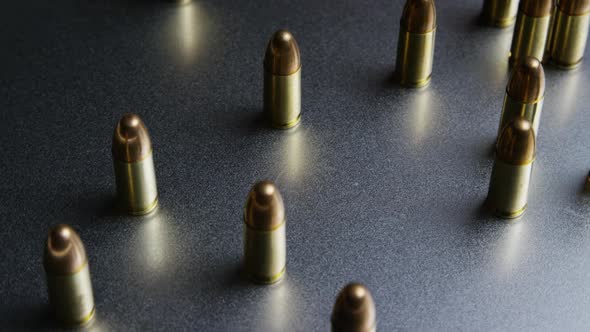 Cinematic rotating shot of bullets on a metallic surface