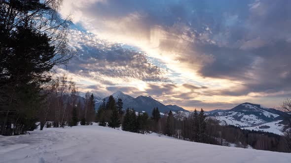 Colorful Golden Sunset Over a Winter Snowy Mountain