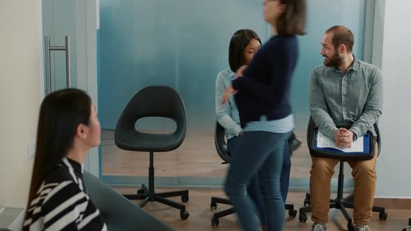 Diverse Group of Candidates Having Conversation in Office Lobby