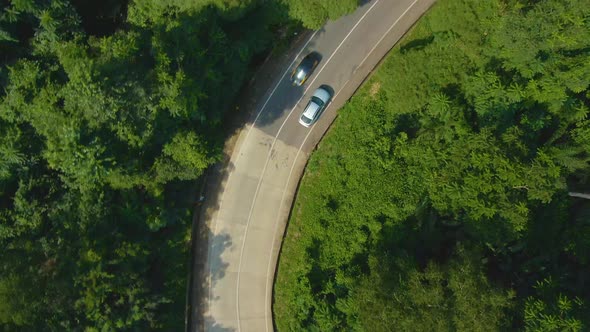 Birds eye view of car on curve road up the hill