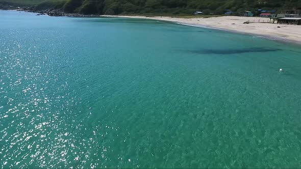 Flying Over the Blue Sea Surface in the Azure Lagoon