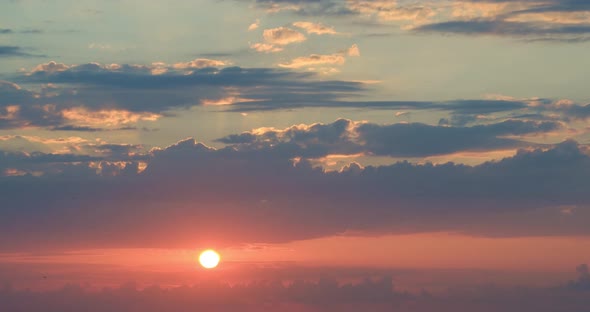 Colorful sunset at the sea. Against the background of the sea, sun goes down