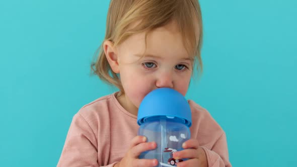 Child Drinks Water From a Bottle