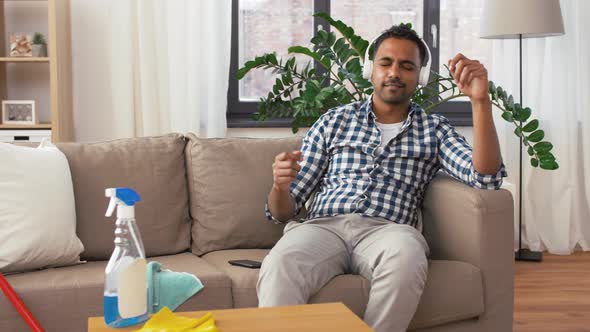 Indian Man in Headphones After Cleaning Home 