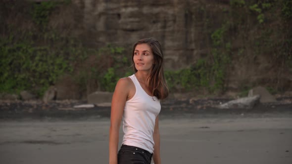 Beautiful Woman Smiling and Posing for Camera at Ocean Shore