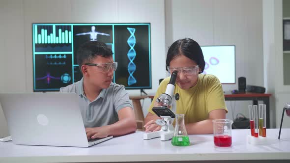 Boy And Girl Learning Science Experiment In Laboratory At Classroom. Study With Scientific Equipment alt