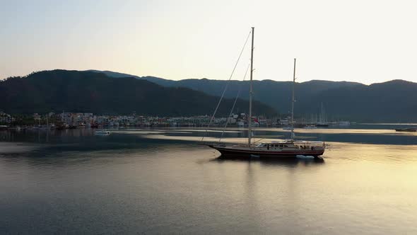 View of Boats with Beautiful City Buildings and Mountains at Sunset