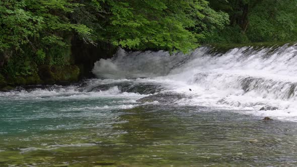 Threshold is Located on a Small Mountain River with Biue Water Flows Between the Stones