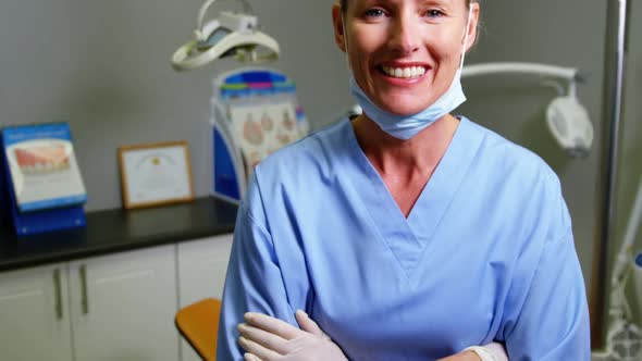 Dental assistant standing with arm crossed in clinic