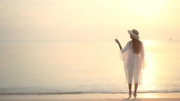 Asian woman enjoy around beautiful beach sea ocean