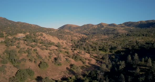 Sierra Nevada mountains and highway in California, golden hour, Aerial Parallax