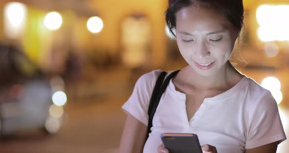 Woman watching on mobile phone at outdoor 