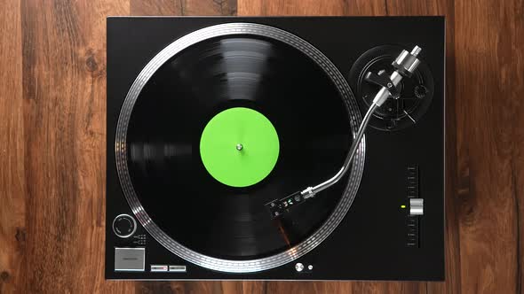 A Black Vinyl Player with Green Title Circle