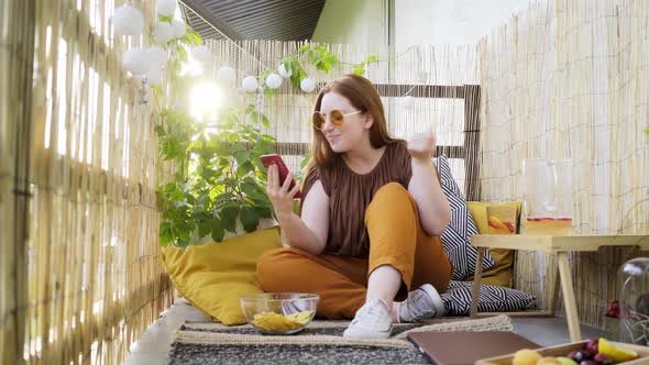 Attractive Woman Using Smartphone on Terrace