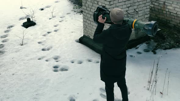 A Man with an Antitank Weapon in an Abandoned House