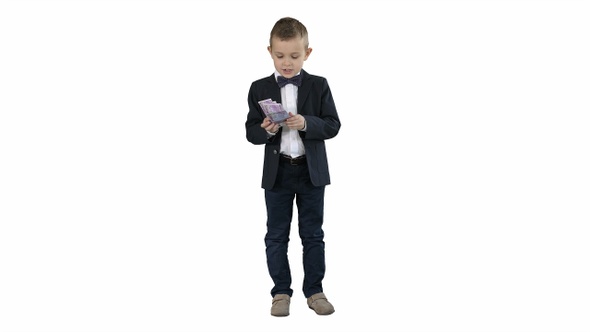 Little boy in a suit counting money on white background