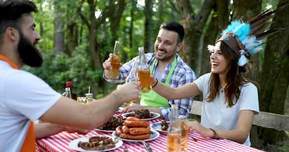 Happy Friends Having a Barbecue Party in Nature