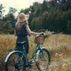Girl In Sunglasses And Dress.ourist Girl Relaxing On Countryside Wildflower Field.Woman Cyclist. - VideoHive Item for Sale