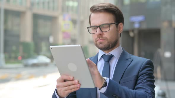 Successful Businessman using Tablet Outdoor