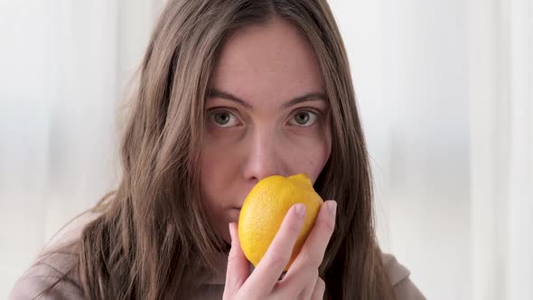 Woman Sniffs Lemon and Does Not Smell