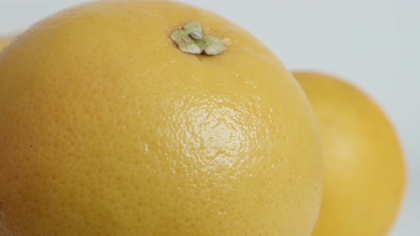 Details of grapefruit Citrus paradisi on white background slow tilt 4K footage