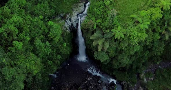 Aerial view from drone flying over nature view of waterfall in the middle of forest. nature is still