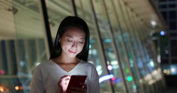 Woman work on cellphone in city