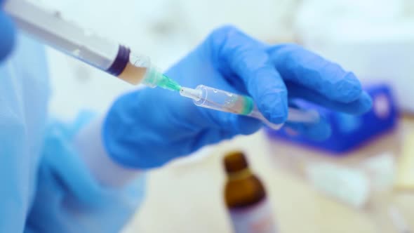 Doctor Holds in His Hand a Syringe with Plasma or with a Closeup Injection for Hair Regeneration and