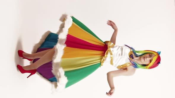 Vertical Studio Shot Flirty Young Woman Touches Her Collarbones After Spinning Around in Sheer