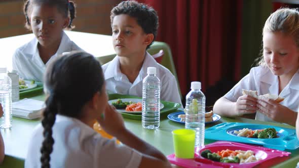 Kids having meal in cafeteria