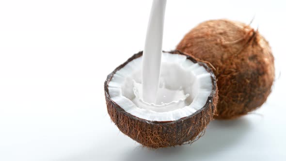 Super Slow Motion Shot of Pouring Milk on Fresh Coconut at 1000Fps