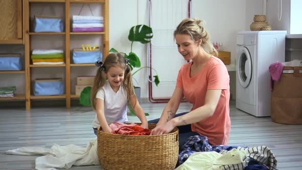 Woman and Kid Sort Dirty and Clean Laundry in Stack Spbd