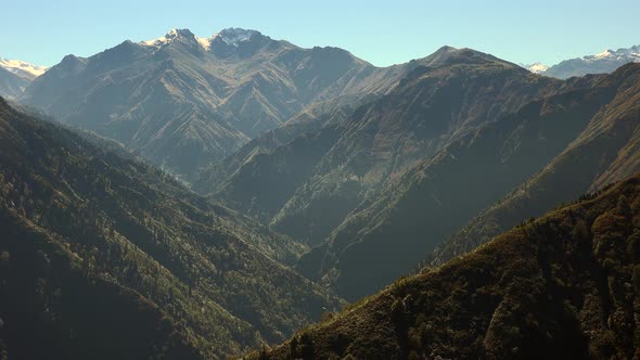 Untouched Natural Wild Woodland Valley and Snowy Mountain Summit