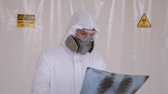 Medical Doctor with Protective Suit Checking Examining Chest Xray Film