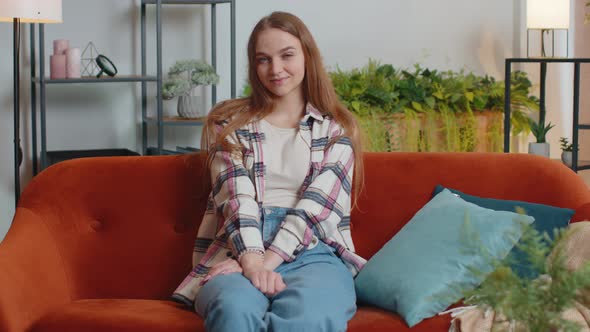 Portrait of Happy One Beautiful Teenager Student Girl Smiling Looking at Camera at Home on Sofa