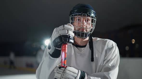 Handheld Portrait of a Forward Hockey Player Seriously Looking at the Camera Steam Coming From the
