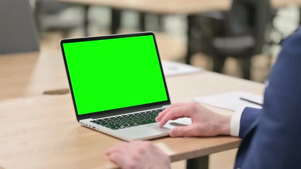 Young Businessman Using Laptop with Chroma Screen