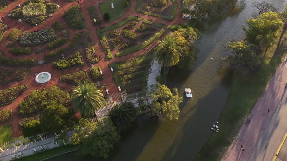Couple on pedal boats at sunset in Palermo Lakes, Tres de Febrero park at Buenos Aires city in Argen