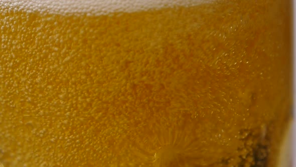 Glass Full of Beer Slow Moving Bubbles.