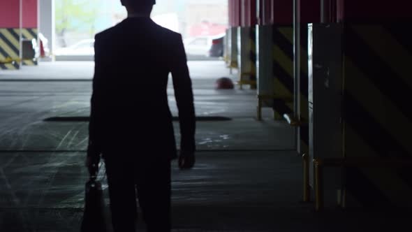 Silhouette of Businessman Leaving Underground Garage