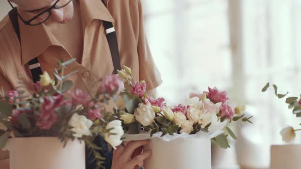 Professional Male Florist Decorating Flower Composition in Hatbox