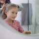 Mother doing daughter's hair - VideoHive Item for Sale