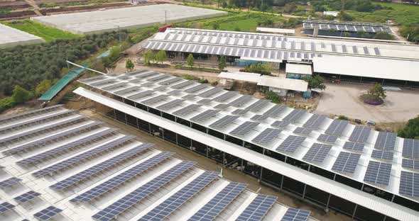 Aerial View of solar panels on the roofs of industrial buildings, Nir David.