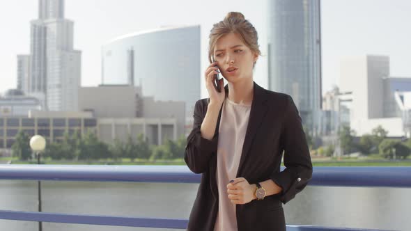 Emotional Business Woman Having Phone Call Outside