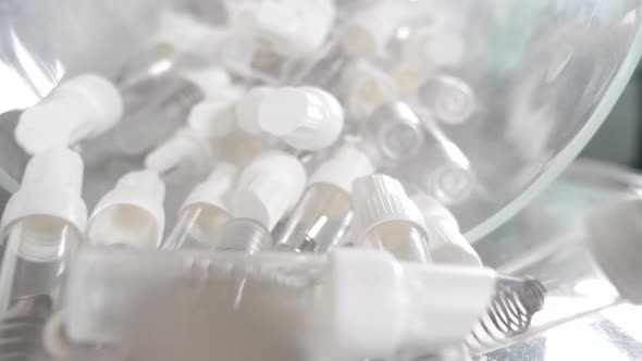 Dental Implant Concept. Lots of Empty Tooth Implants Containers Moving in Slow Motion Into Camera