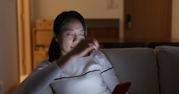 Woman Look at Mobile Phone and Sit on Sofa