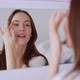 Glad Female Applying Concealer and Smiling - VideoHive Item for Sale