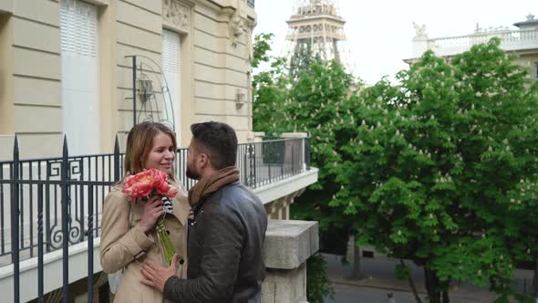 A Man Gives a Woman a Bouquet of Flowers