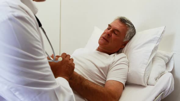 Doctor visiting patient and holding hands