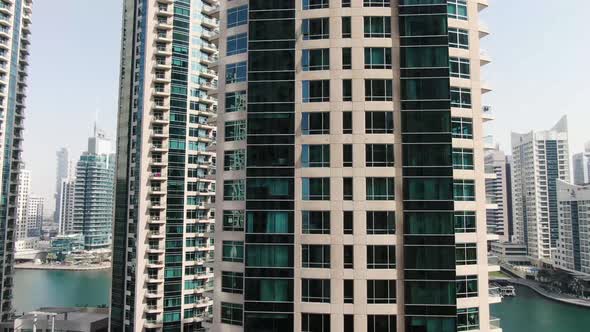 Drone is Ascending Near a Huge Residential Building in Dubai Marina